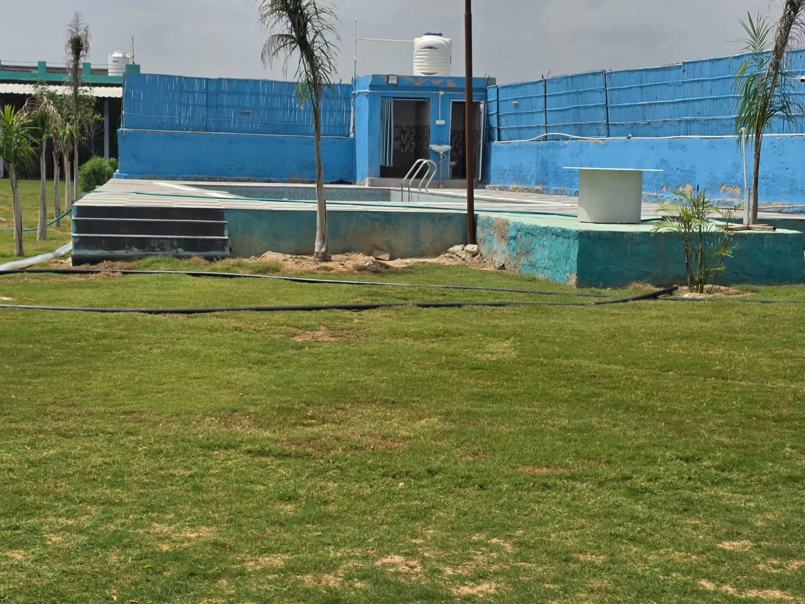 Clyrova Farmhouse lawn and pool party venue near Bagru