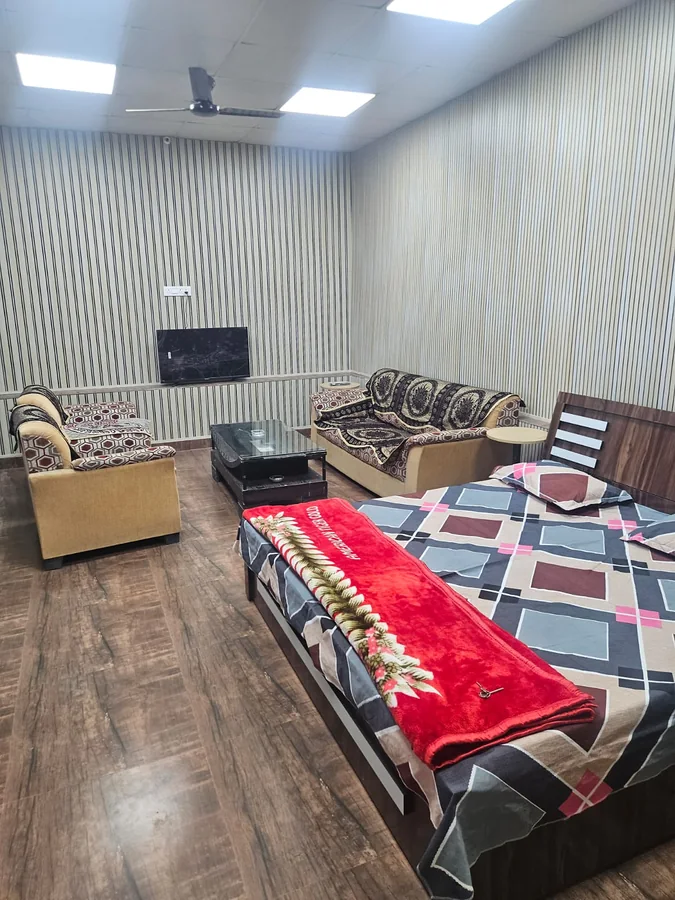 Premium family room with bed and two sofas at Clyrova Farmhouse